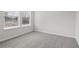 Well-lit bedroom featuring grey carpet and two windows at 3913 Brushy St, Powder Springs, GA 30127