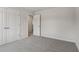 Spacious bedroom with grey carpet and double doors leading to a bathroom at 3913 Brushy St, Powder Springs, GA 30127