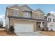 Two-story house with stone accents and a large front yard at 3913 Brushy St, Powder Springs, GA 30127