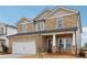 Two-story house with stone accents and a large front yard at 3913 Brushy St, Powder Springs, GA 30127