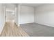 Light hallway with wood-look flooring and carpeted area at 3913 Brushy St, Powder Springs, GA 30127