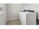 Convenient laundry room with washer, dryer, and overhead shelving at 3913 Brushy St, Powder Springs, GA 30127