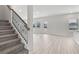 Modern staircase with metal balusters leading to an open living area at 3913 Brushy St, Powder Springs, GA 30127