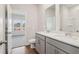 Double vanity bathroom with grey cabinets and access to bedroom at 3933 Brushy St, Powder Springs, GA 30127