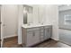 Double vanity bathroom with gray cabinets and a large mirror at 3933 Brushy St, Powder Springs, GA 30127