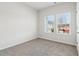 Bright bedroom with carpet flooring and two windows at 3933 Brushy St, Powder Springs, GA 30127