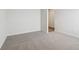 Well-lit bedroom featuring grey carpet and an open doorway at 3933 Brushy St, Powder Springs, GA 30127