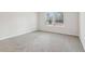 Well-lit bedroom with grey carpet and two windows at 3933 Brushy St, Powder Springs, GA 30127
