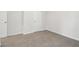 Empty bedroom with carpet flooring and a door at 3933 Brushy St, Powder Springs, GA 30127