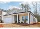 Single story home with gray siding, white brick, and a covered porch at 3933 Brushy St, Powder Springs, GA 30127