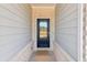 Black front door entry with glass panels and brick surround at 3933 Brushy St, Powder Springs, GA 30127