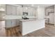 Modern kitchen with island, granite countertops, and gray cabinets at 3933 Brushy St, Powder Springs, GA 30127