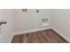 Clean laundry room with wood-look flooring and built-in shelving at 3933 Brushy St, Powder Springs, GA 30127