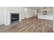Open living room with fireplace and kitchen views, hardwood floors throughout at 3933 Brushy St, Powder Springs, GA 30127