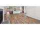 Open living area with hardwood floors and fireplace, view of kitchen at 3933 Brushy St, Powder Springs, GA 30127