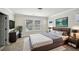 Staged main bedroom featuring large bed, lamps, mounted tv and two windows at 4750 Hemingway Trl, Cumming, GA 30041