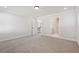 Expansive carpeted room with open doorway, neutral walls, and bright lighting at 4775 Marjorie Dr, Cumming, GA 30041