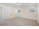 Bright and airy bedroom with neutral carpet and a view through the window at 4835 Marjorie Dr, Cumming, GA 30041