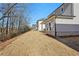 Side yard showing the home's siding, covered patio, and surrounding yard at 4835 Marjorie Dr, Cumming, GA 30041