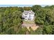 Aerial view of a stunning property surrounded by lush greenery and mature trees at 8380 Sentinae Chase Dr, Roswell, GA 30076