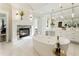 Luxurious bathroom with marble floors, standalone tub, fireplace, and vanity at 8380 Sentinae Chase Dr, Roswell, GA 30076