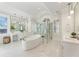Bright, modern bathroom with freestanding tub, glass shower, and dual vanities at 8380 Sentinae Chase Dr, Roswell, GA 30076