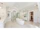 Elegant bathroom with a glass enclosed shower, soaking tub and dual sink vanity at 8380 Sentinae Chase Dr, Roswell, GA 30076