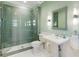 Contemporary bathroom featuring a glass enclosed shower with subway tile and pedestal sink at 8380 Sentinae Chase Dr, Roswell, GA 30076