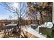 Outdoor deck area with full dining set and seating, featuring wooded view and room to relax at 8380 Sentinae Chase Dr, Roswell, GA 30076