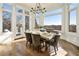 Inviting dining room with hardwood floors and many windows overlooking the trees at 8380 Sentinae Chase Dr, Roswell, GA 30076