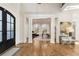 Welcoming foyer with beautiful hardwood floors, a black front door, and elegant archways to other rooms at 8380 Sentinae Chase Dr, Roswell, GA 30076