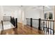 Upstairs hallway boasts hardwood floors, detailed trim, and natural light at 8380 Sentinae Chase Dr, Roswell, GA 30076