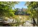 Picturesque view of the lake framed by lush greenery, creating a tranquil and scenic setting at 8380 Sentinae Chase Dr, Roswell, GA 30076