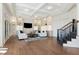 Sophisticated living room showcasing built-in shelving, coffered ceilings and staircase at 8380 Sentinae Chase Dr, Roswell, GA 30076