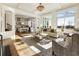 Spacious living room open to kitchen, features fireplace, hardwood floors, and large windows for abundant natural light at 8380 Sentinae Chase Dr, Roswell, GA 30076