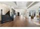 Elegant living room with hardwood floors, coffered ceilings, and a grand staircase at 8380 Sentinae Chase Dr, Roswell, GA 30076