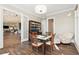 Inviting living space showcasing a stylish chess table, cozy chair, and seamless flow to the adjacent living area at 8380 Sentinae Chase Dr, Roswell, GA 30076