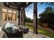 Relaxing outdoor patio with comfortable seating, elegant lighting, and serene views of the landscaped backyard at 8380 Sentinae Chase Dr, Roswell, GA 30076