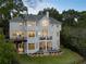 Stunning rear exterior showcasing a multilevel deck, patios, and manicured landscaping for outdoor enjoyment at 8380 Sentinae Chase Dr, Roswell, GA 30076