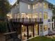 Expansive rear exterior with a deck, covered patio, and multiple windows offering abundant natural light at 8380 Sentinae Chase Dr, Roswell, GA 30076