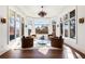 Cozy sitting area with a view of the autumn trees, featuring a unique light fixture at 8380 Sentinae Chase Dr, Roswell, GA 30076