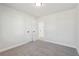 Simple bedroom with grey carpet and access to other rooms at 4755 Marjorie Dr, Cumming, GA 30041