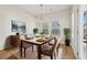 Elegantly staged dining room with hardwood floors and large windows at 4755 Marjorie Dr, Cumming, GA 30041