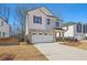 Two-story home with a two-car garage and front yard at 4755 Marjorie Dr, Cumming, GA 30041