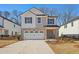 Two-story brick home with a white garage door and landscaping at 4755 Marjorie Dr, Cumming, GA 30041