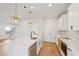 Open concept kitchen with white cabinets and a large island at 4755 Marjorie Dr, Cumming, GA 30041