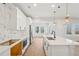 Modern kitchen with white cabinets, a large island, and a mosaic backsplash at 4755 Marjorie Dr, Cumming, GA 30041