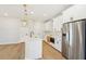 Modern kitchen with white cabinets, stainless steel appliances, and a large island at 4755 Marjorie Dr, Cumming, GA 30041