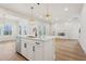 Modern kitchen with white cabinets, quartz countertops, and a large island at 4755 Marjorie Dr, Cumming, GA 30041