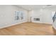Living room with hardwood floors, fireplace, and large windows at 4755 Marjorie Dr, Cumming, GA 30041